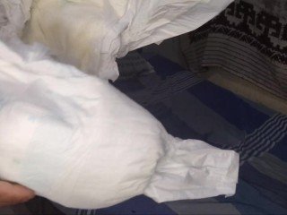 young man urinates his diaper and masturbates